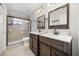 Modern bathroom with a tiled walk-in shower and separate double vanities at 12720 Greco Dr, Orlando, FL 32824