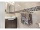 Chic half-bathroom featuring modern vanity with decorative tile accent and towel rack at 12720 Greco Dr, Orlando, FL 32824