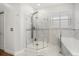 Modern bathroom featuring an enclosed glass shower and a soaking tub at 12720 Greco Dr, Orlando, FL 32824