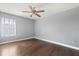 Cozy bedroom featuring a ceiling fan, a window with blinds, and hardwood flooring at 12720 Greco Dr, Orlando, FL 32824