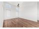 An empty bedroom featuring wood floors, a ceiling fan, and natural light from 3 windows at 12720 Greco Dr, Orlando, FL 32824
