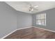 Bedroom with ceiling fan, a window with blinds, and laminate flooring at 12720 Greco Dr, Orlando, FL 32824
