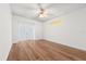 Modern bedroom featuring light hardwood floors, ceiling fan, and French doors at 12720 Greco Dr, Orlando, FL 32824