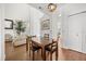 Well-lit dining area with wood floors, a large window, and modern light fixture at 12720 Greco Dr, Orlando, FL 32824