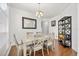 Formal dining room featuring wood floors, a chandelier, and a large framed mirror at 12720 Greco Dr, Orlando, FL 32824
