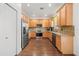 Spacious kitchen with stainless steel appliances, wood cabinets, and stone countertops at 12720 Greco Dr, Orlando, FL 32824