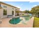Backyard pool with an adjacent patio and lush landscaping, perfect for relaxation and entertainment at 12720 Greco Dr, Orlando, FL 32824