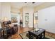 Comfortable living room with a leather recliner, murphy bed, and view into bathroom at 14336 Dulcimer Ct, Orlando, FL 32837