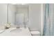 This bathroom boasts a bright countertop with a white vessel sink, a large mirror, and a shower curtain at 14345 Wabasso Loop, Winter Garden, FL 34787