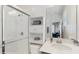 Bright bathroom featuring a glass shower, built-in storage, and a granite-topped vanity with a modern sink at 14345 Wabasso Loop, Winter Garden, FL 34787