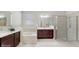 Bathroom featuring a glass-enclosed shower, separate soaking tub, and double vanity at 14345 Wabasso Loop, Winter Garden, FL 34787