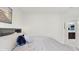 Bedroom featuring a comfortable bed, stylish side tables with lamps, and a view of a bathroom in the background at 14345 Wabasso Loop, Winter Garden, FL 34787