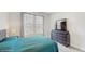 This cozy bedroom features large windows, plush carpet, and a dresser with a TV at 14345 Wabasso Loop, Winter Garden, FL 34787