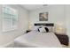 Bedroom featuring a comfortable bed, stylish side tables with lamps, and a bright window view at 14345 Wabasso Loop, Winter Garden, FL 34787
