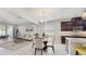 Cozy dining area featuring a modern light fixture and seamless flow into the kitchen and living space at 14345 Wabasso Loop, Winter Garden, FL 34787