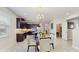 Open concept kitchen and dining area with dark cabinets, stainless appliances, and a light and bright feel at 14345 Wabasso Loop, Winter Garden, FL 34787