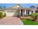 Charming single-story home with well-manicured landscaping and a brick paved driveway at 14345 Wabasso Loop, Winter Garden, FL 34787