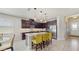 Modern kitchen features stainless steel appliances, granite counters and a spacious island with breakfast bar seating at 14345 Wabasso Loop, Winter Garden, FL 34787