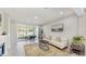 Bright living room features neutral decor, wood floors, and sliding glass doors to the patio at 14345 Wabasso Loop, Winter Garden, FL 34787