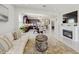 Open-concept living area with a fireplace, modern furnishings, and seamless flow into the dining area and kitchen at 14345 Wabasso Loop, Winter Garden, FL 34787