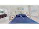 Light-filled primary bedroom features an ensuite bathroom, two nightstands, and tile floors at 14345 Wabasso Loop, Winter Garden, FL 34787