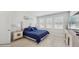 Bright primary bedroom features tile floors, a decorative headboard, and ample natural light at 14345 Wabasso Loop, Winter Garden, FL 34787