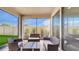 Inviting screened patio with outdoor seating, overlooking a well-maintained yard and garden at 14345 Wabasso Loop, Winter Garden, FL 34787