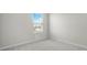 The carpeted bedroom features a window with mini blinds for pleasant lighting at 1506 Finnigan Cir, Haines City, FL 33844
