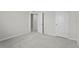Vacant carpeted bedroom features a window for natural light and white walls at 1506 Finnigan Cir, Haines City, FL 33844