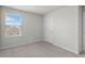 Bright bedroom featuring a window with blinds, neutral carpeting, and white walls at 1506 Finnigan Cir, Haines City, FL 33844