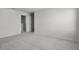 Neutral bedroom with plush carpeting, a closed white door, and ample wall space for decor, offering a serene ambiance at 1506 Finnigan Cir, Haines City, FL 33844