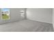 Spacious bedroom with plush gray carpeting and natural light from dual windows at 1506 Finnigan Cir, Haines City, FL 33844