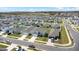 Aerial view of a residential street featuring identical two-story homes, manicured lawns, and ample parking spaces at 1506 Finnigan Cir, Haines City, FL 33844