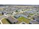 Expansive aerial view of a new construction community with consistent home styles and manicured lawns under a clear sky at 1506 Finnigan Cir, Haines City, FL 33844