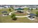 Community park with covered picnic pavilions and a playground surrounded by lush green space and residential homes at 1506 Finnigan Cir, Haines City, FL 33844