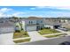 Aerial view of a two-story home with a two-car garage, in a residential community with well-maintained lawns at 1506 Finnigan Cir, Haines City, FL 33844