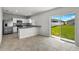 Stylish eat-in kitchen with stainless appliances, white cabinets, and access to a green backyard at 1506 Finnigan Cir, Haines City, FL 33844
