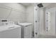 Laundry room with appliances, shelving, and access to another room at 1506 Finnigan Cir, Haines City, FL 33844