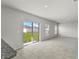 Open-concept living area with neutral colors, tile and carpet flooring, and patio access at 1506 Finnigan Cir, Haines City, FL 33844