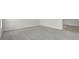 Expansive open-plan living room featuring gray carpet and seamless transition to tiled entry at 1506 Finnigan Cir, Haines City, FL 33844