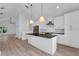 Stylish kitchen highlights white cabinetry, stainless steel appliances, and an island with a sink at 1602 Park Lake St # 2, Orlando, FL 32803