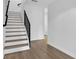 Modern staircase boasts light wood stairs, sleek black railing, and minimalist design at 1602 Park Lake St # 2, Orlando, FL 32803