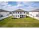 Aerial view of a spacious backyard with lush green grass and a well-maintained two-story home at 1639 Meadowlark Dr, Deltona, FL 32725