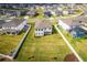 Aerial view of a spacious, well-maintained backyard with a white fence and lush green grass at 1639 Meadowlark Dr, Deltona, FL 32725