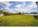Large backyard showcasing lush green grass and white fencing for privacy and security at 1639 Meadowlark Dr, Deltona, FL 32725