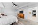 Bright bedroom leads into main bathroom with neutral walls, carpet flooring, and a large dresser at 1639 Meadowlark Dr, Deltona, FL 32725