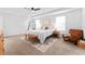Bright bedroom with a ceiling fan, neutral walls, carpet flooring, and a decorative rug under the bed at 1639 Meadowlark Dr, Deltona, FL 32725