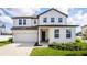 Charming two-story home with a well-manicured lawn and driveway, featuring modern architectural details at 1639 Meadowlark Dr, Deltona, FL 32725