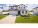 Charming two-story home with a well-manicured lawn and driveway, featuring modern architectural details at 1639 Meadowlark Dr, Deltona, FL 32725