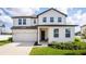 Charming two-story home featuring a white exterior, well-manicured lawn, and attached two car garage at 1639 Meadowlark Dr, Deltona, FL 32725